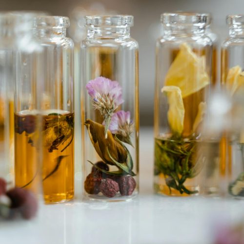 Clear Glass Bottles with Liquid and Dry Flowers